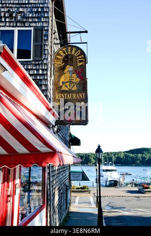 BAR HARBOR, MAINE, USA - AUGUST 7, 2010: Quarterdeck restaurant sign and red striped awning on a weathered shingle building facing the harbor Stock Photo