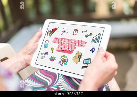 Marketing plan concept shown on a tablet held by a woman Stock Photo
