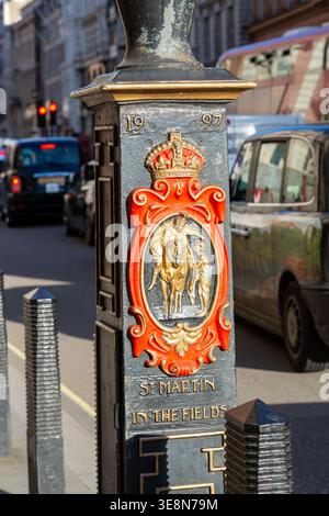 St Martin in the Fields plaque on a cast iron lampost in the Strand, London. Stock Photo