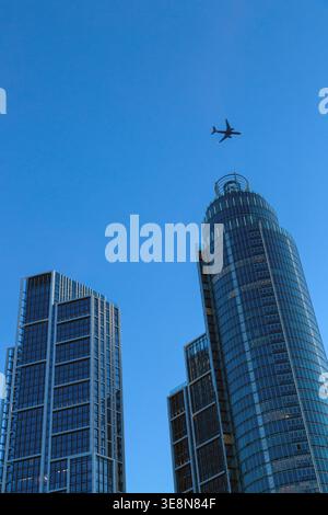 An airplane flying over the St George Wharf Tower, also known as the Vauxhall Tower, located in London Stock Photo