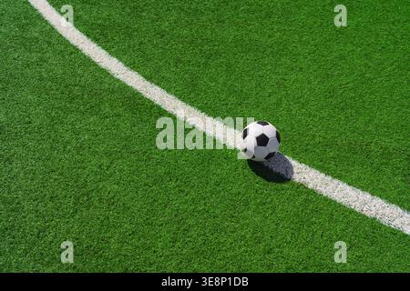 a soccer ball on the green grass in soccer stadium. Stock Photo