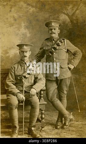 WW1 vintage black white photo 2 soldiers, World war one military men in uniform  Royal Artillery Gunners - they wear spurs, riding crops dated 1916 Stock Photo