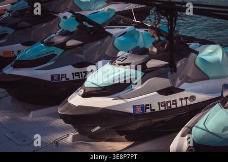 KEY WEST, FLORIDA, USA - OCTOBER 27, 2025: A fleet of modern Sea-Doo jet skis lined up at a floating dock in Key West, ready for rental and tropical o Stock Photo