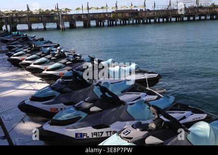 KEY WEST, FLORIDA, USA - OCTOBER 27, 2025: A fleet of modern Sea-Doo jet skis lined up at a floating dock in Key West, ready for rental and tropical o Stock Photo