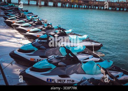 KEY WEST, FLORIDA, USA - OCTOBER 27, 2025: A fleet of modern Sea-Doo jet skis lined up at a floating dock in Key West, ready for rental and tropical o Stock Photo