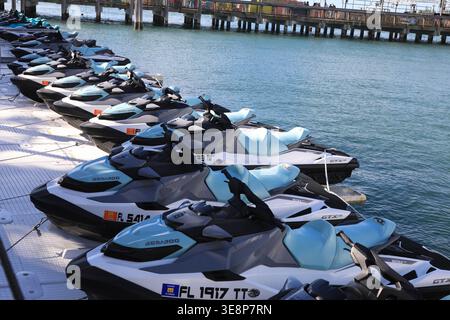 KEY WEST, FLORIDA, USA - OCTOBER 27, 2025: A fleet of modern Sea-Doo jet skis lined up at a floating dock in Key West, ready for rental and tropical o Stock Photo