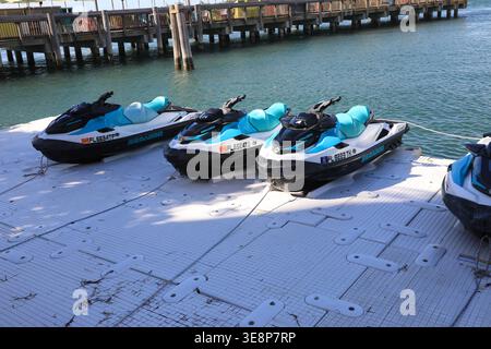 KEY WEST, FLORIDA, USA - OCTOBER 27, 2025: A fleet of modern Sea-Doo jet skis lined up at a floating dock in Key West, ready for rental and tropical o Stock Photo
