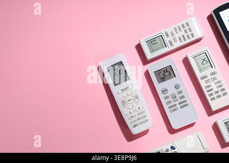 Air conditioner remote controls on pink background Stock Photo