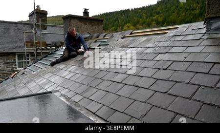Roof repairs using local Welsh Slate Stock Photo