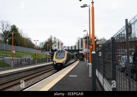 CrossCountry Voyager diesel train passing through Kings Heath railway station, Birmingham, West Midlands, England, UK Stock Photo