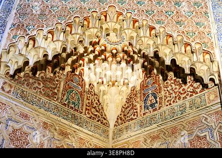 Madrasa of Granada features intricate architectural details. Visitors can observe the beautiful patterns and carvings on the walls and ceiling. Stock Photo