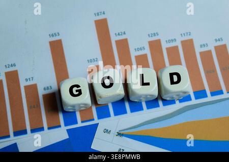 Concept of text gold on wooden blocks. For investment wealth Stock Photo