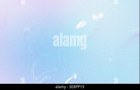 Gently fading blue and purple creating a textured backdrop with subtle grainy details and light reflections Stock Photo