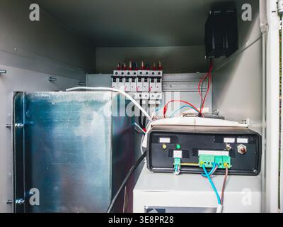 Close-up view of electrical components and wiring inside a metal enclosure for telecommunications equipment Stock Photo