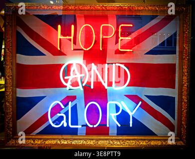 Neon Hope and Glory sign over a Union Jack, evoking Brexit, nationalism, imperial nostalgia and divisive British political themes. Stock Photo