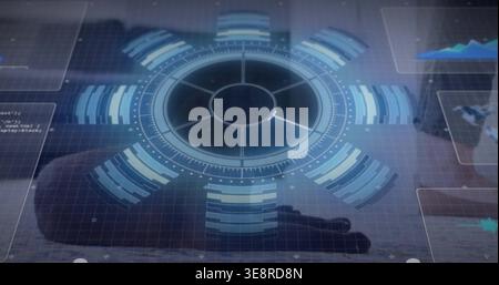 Projecting holographic circular HUD hovering above reflective lab table, with hand in dark sleeve Stock Photo