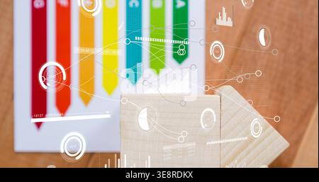 Showing two light wooden blocks forming arrow on wood table, colored chart ribbons and HUD overlays Stock Photo