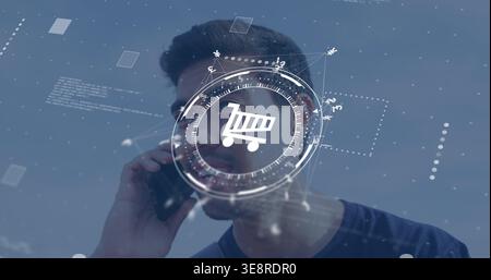 Holding smartphone, adult male wearing dark crew-neck T-shirt listening in studio with AR cart HUD Stock Photo