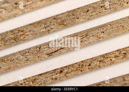 chipboard plate materials from a large amount of sawdust joined together, several boards from pine sawdust that can be used for construction, mdf text Stock Photo