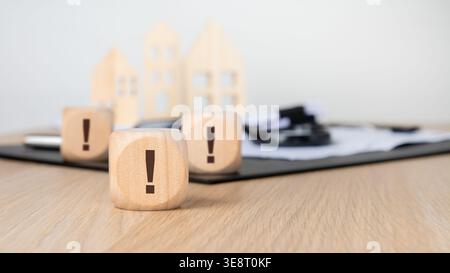 Close-up of several wooden blocks with exclamation marks resting on a desk, with the front block in sharp focus. Perfect for highlighting a checklist Stock Photo