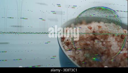Glitching wide band revealing white-rim bowl magnifying pink rock salt on blue table, copy space Stock Photo
