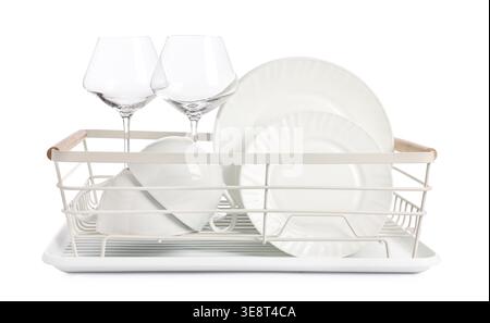 Clean dishes, cups and glasses in drying rack on white background Stock Photo