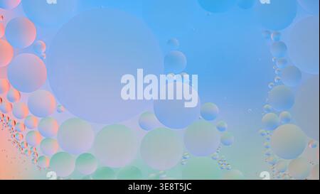 Macro view of soft pastel bubbles in a blue liquid, forming a delicate abstract background with smooth gradients and a light, airy aesthetic. Stock Photo