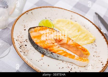 Grilled salmon steak served on plate with mashed potatoes Stock Photo