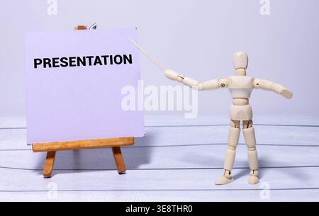 Vertical shot of young male Spanish instructor demonstrating vocabulary memorization method to learners pointing at question words on whiteboard durin Stock Photo