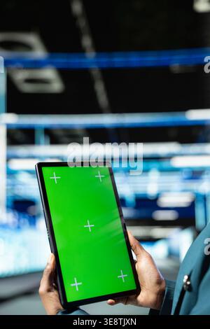 Green screen tablet, technology and programmer in data center managing enterprise solutions. Supervising IT operations, chroma key device close up and employee in futuristic server room Stock Photo