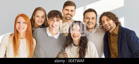 Happy diverse student group smiling together, teamwork and friendship in studio Stock Photo