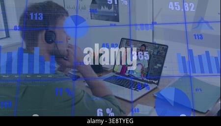 Leaning man green shirt, headphones, viewing laptop at desk with pens and data overlays, copy space Stock Photo