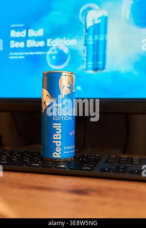 Tyumen, Russia-March 20, 2026: Blue Red Bull can on a gamer desk with a blurred computer screen, symbolizing the lifestyle of esports athletes Stock Photo