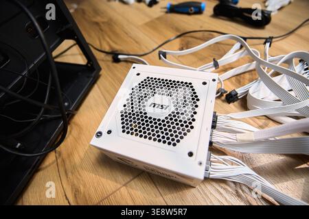 Tyumen, Russia-February 15, 2026: MSI power supply sits next to a black bag in a home workspace Stock Photo