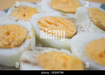 Eggs are cut in half on a plate Stock Photo