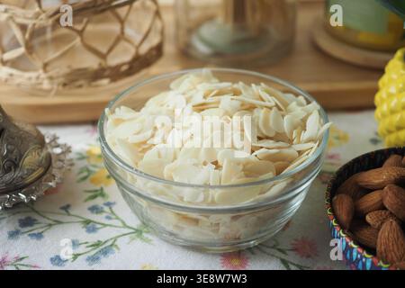 Slices of almonds in a clear bowl on a table Stock Photo