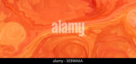 Abstract orange liquid marble texture with swirling acrylic paint Stock Photo
