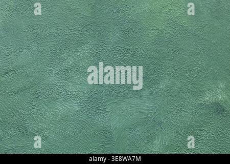 Textured turquoise painted wall surface with cracked weathered paint and rough pattern Stock Photo