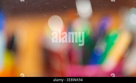 Abstract colorful bokeh background with multicolored blurred light circles through glass Stock Photo