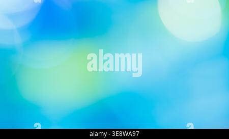 Bright blue and green abstract bokeh background with glowing circular light spots Stock Photo