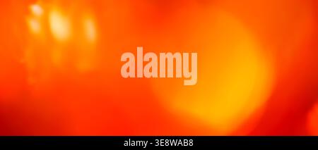Vivid red and orange abstract blurred background with warm light bokeh effect Stock Photo