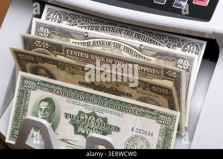 Old Philippine money - peso in the counting machine Stock Photo