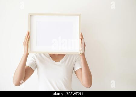 Wooden frames with empty space in the bedroom. Templates for decorating a room. Minimalist interior in rustic or boho style. Blank forms for your pres Stock Photo