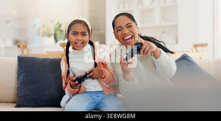 Video game, mother and girl in home, smile and laughing for victory, fun and happy in living room. Esports, family and mama in lounge, funny and Stock Photo