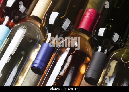 Red, rose and white wine bottles on stone table. Top view Stock Photo