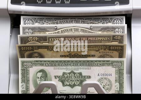Old Philippine money - peso in the counting machine Stock Photo