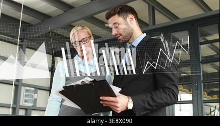 Checking documents, two coworkers in suit and blouse in office, black clipboard, data overlays Stock Photo