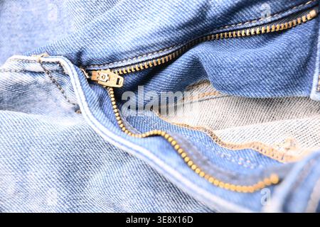 Blue Denim Jeans with Brass Zip and Buttons — Creased Fabric Texture Macro Close-Up with Soft Defocused Backgrounds Stock Photo