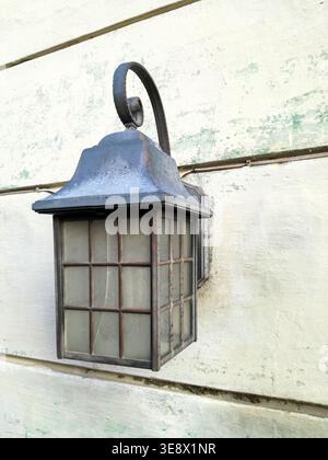 Street light. Antique street lamp on painted wooden wall of old building. Close-up. Copy space Stock Photo