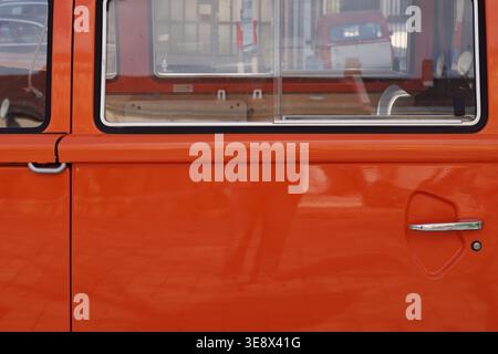 View through the side windows of an orange vintage bus Stock Photo
